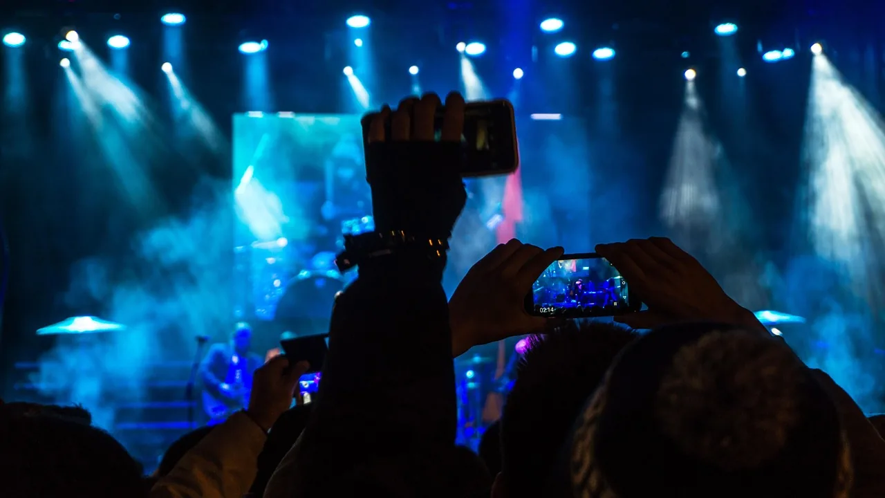 Audience filming a concert in a club Audience filming a concert in a club