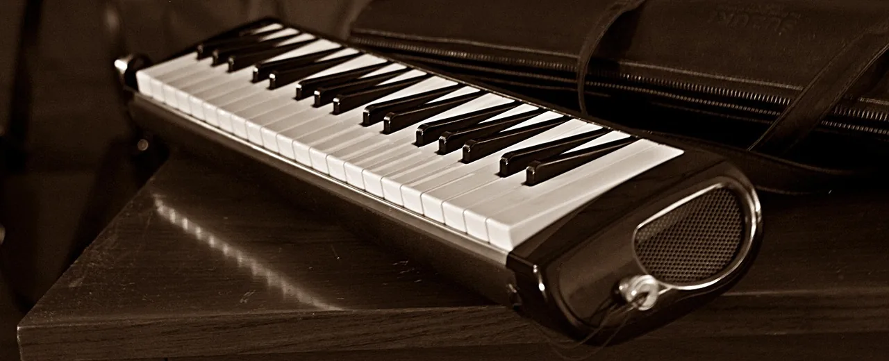 Black melodica resting on a table Black melodica resting on a table