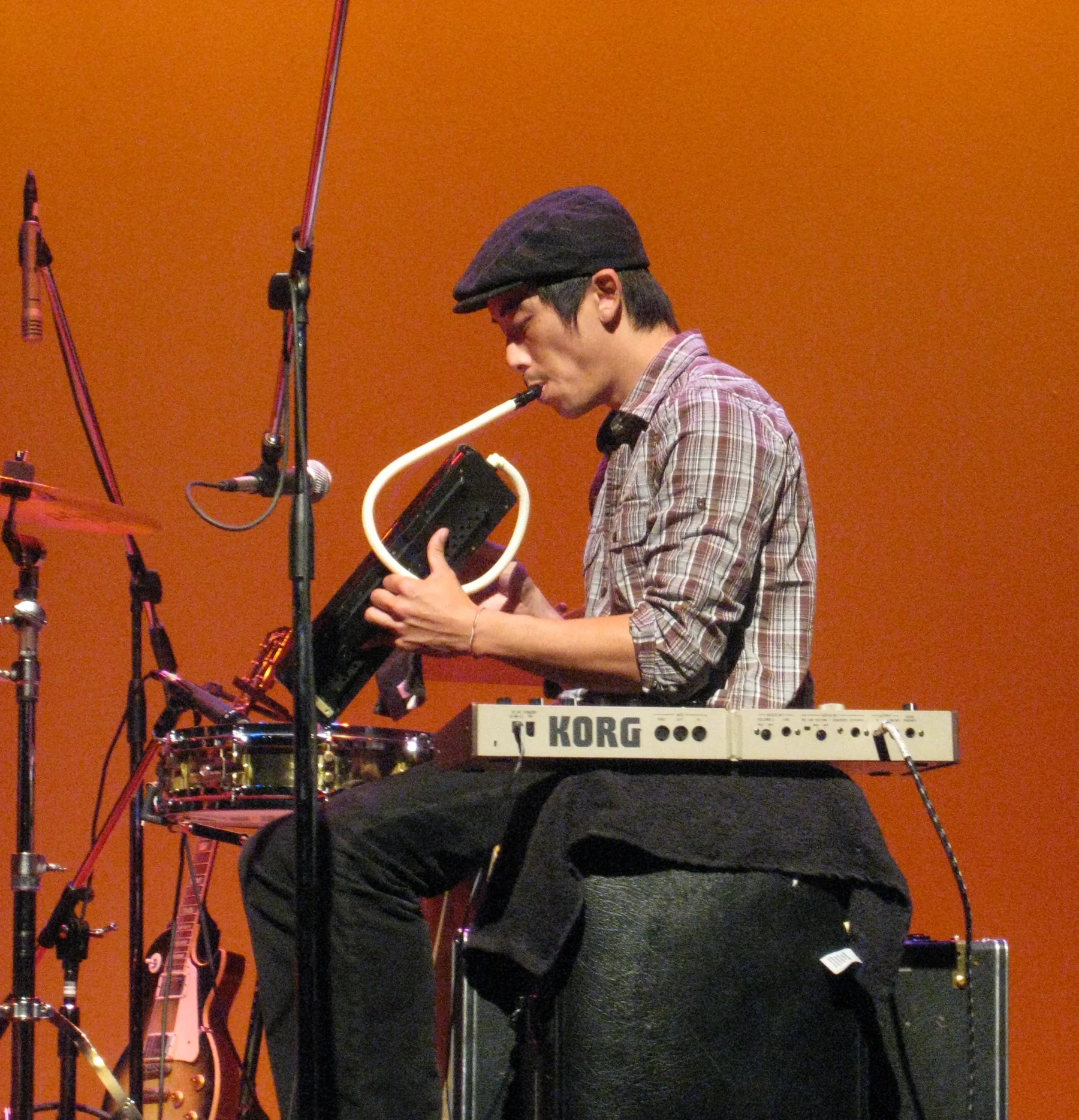 Musician playing a melodica on stage Musician playing a melodica on stage