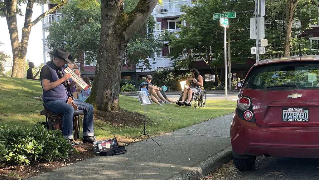 Musician playing a bass melodica outdoors Musician playing a bass melodica outdoors